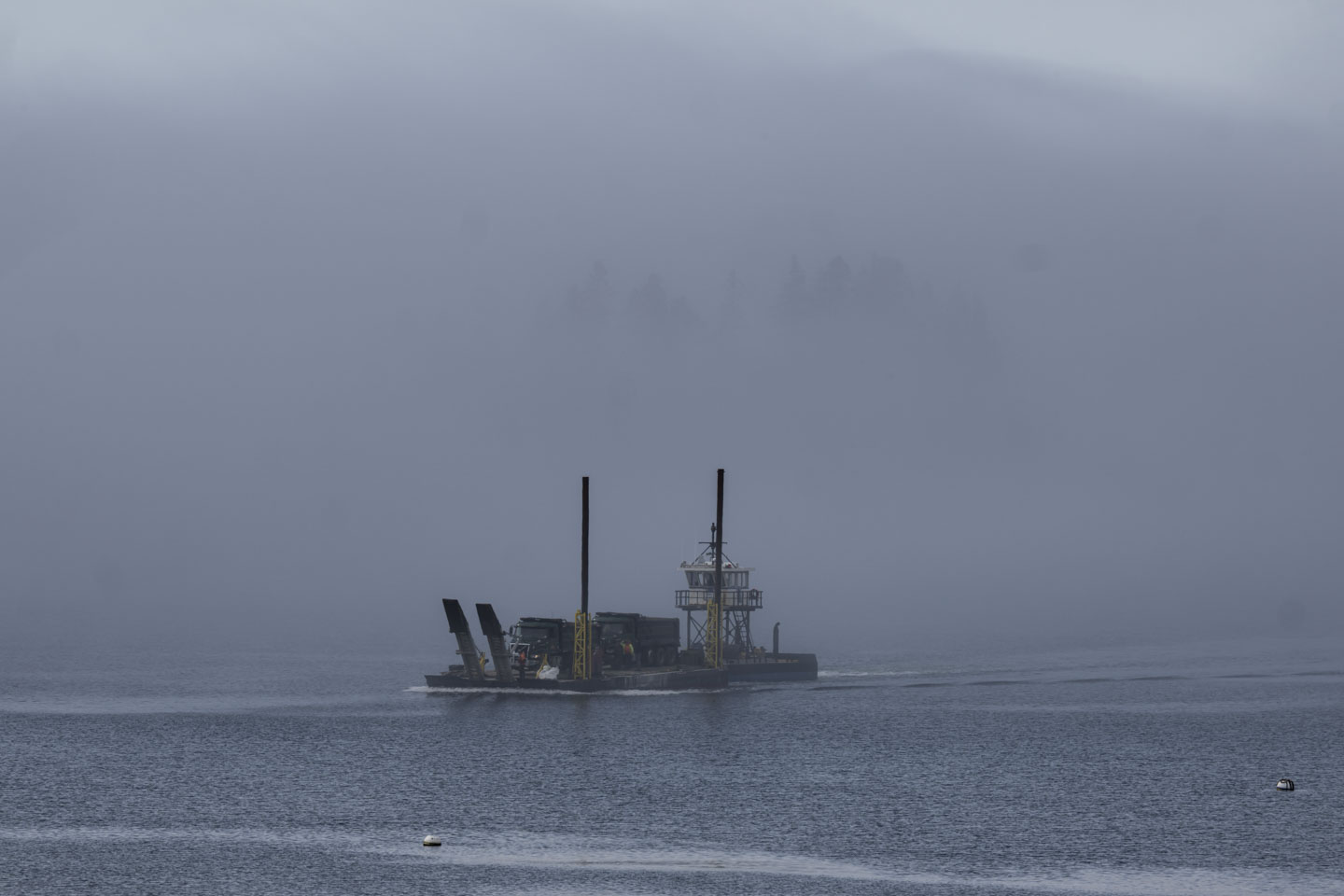 The float can be seen in the fog, returning with empty trucks.