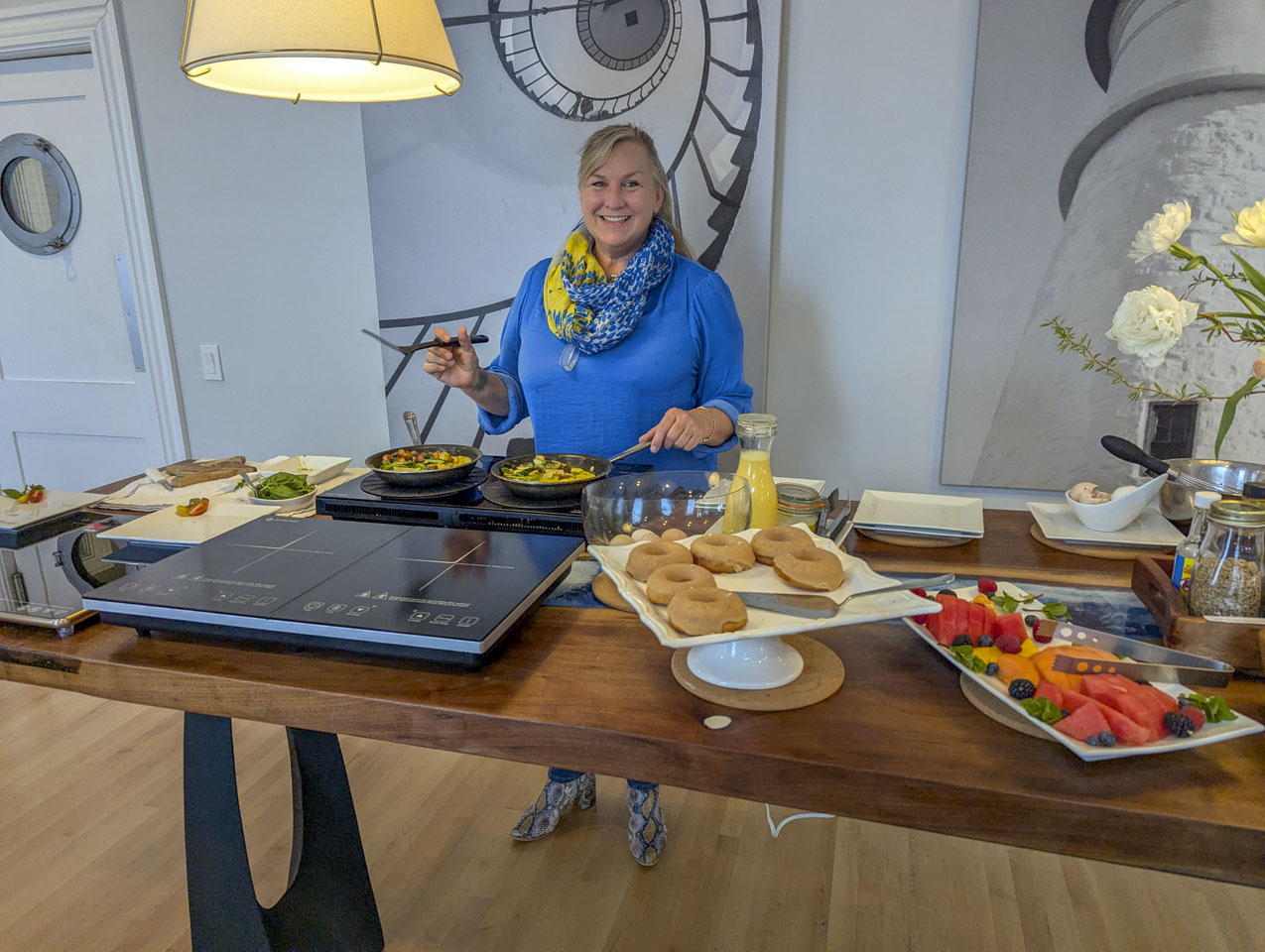 Rebekah is wearing a bright blue shirt and is making omelets.