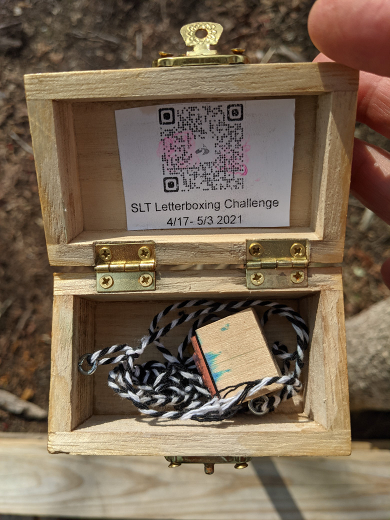 Open treasure hunt box showing the rubber stamp