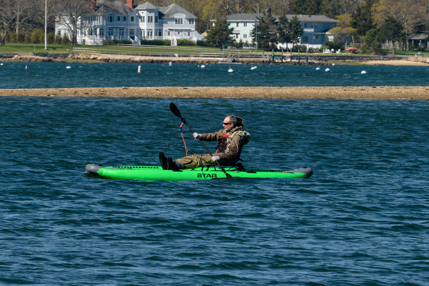 Man sitting on a green paddleboard
