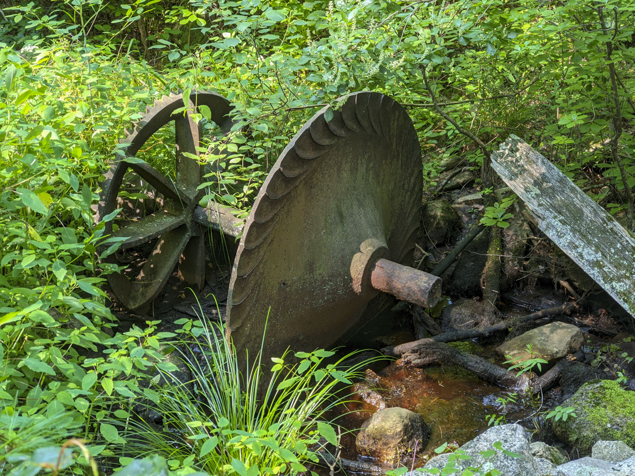 A rusty piece of formed metal that was probably involved with water power