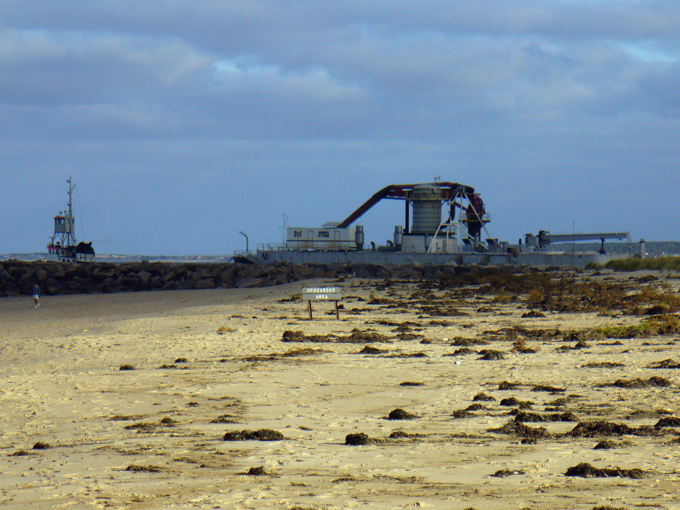 Scusset Beach canal breakwater with a tugboat and barge on the other side